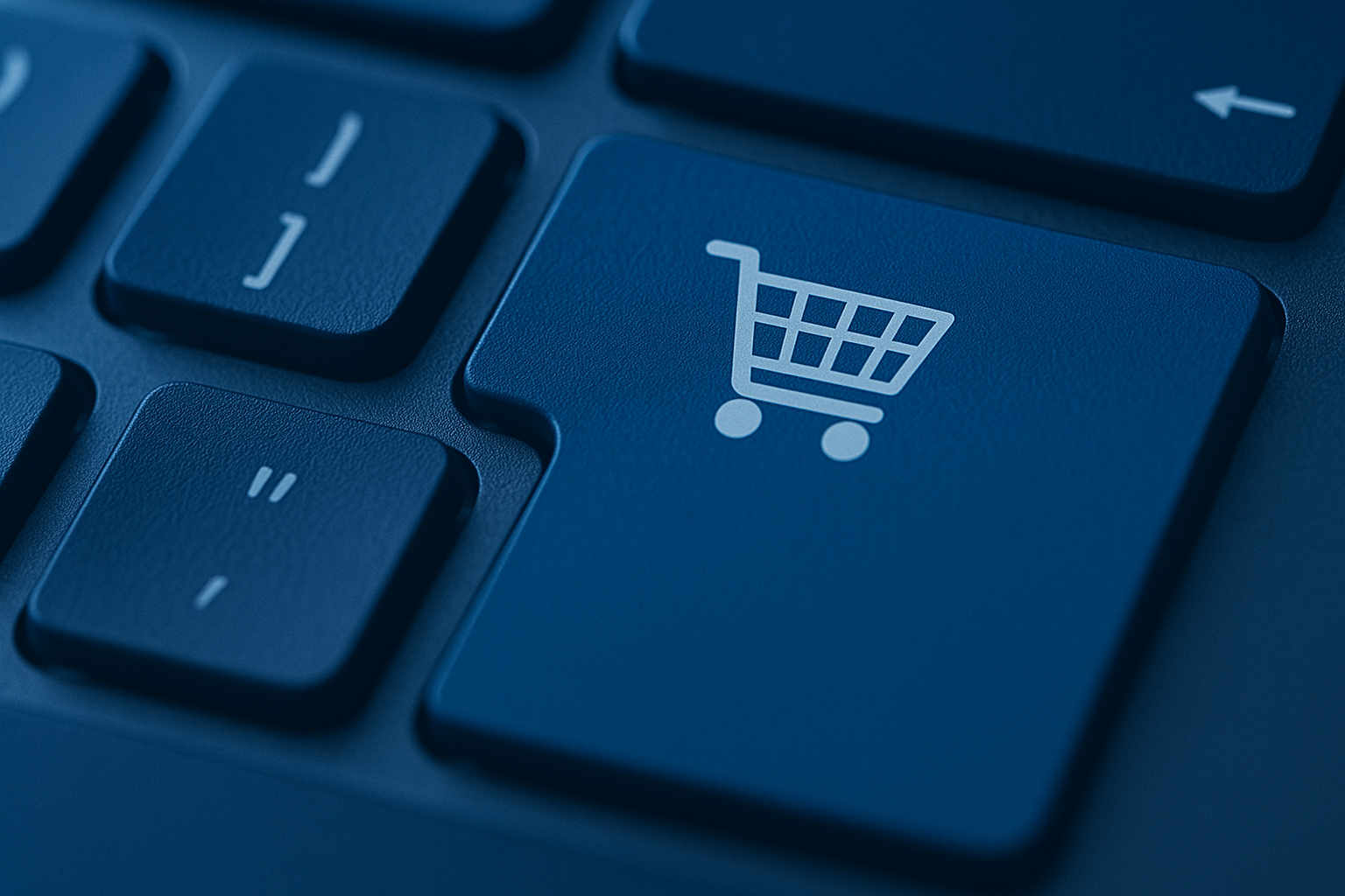 Close-up of a keyboard key with a shopping cart icon symbolizing online shopping and digital transactions.